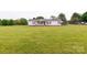 Traditional single-story home with a covered porch, landscaped yard, and a detached carport for extra parking at 404 St Lukes Church Rd, Kings Mountain, NC 28086