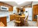 Charming kitchen with wooden cabinetry, white appliances, and a cozy dining area, perfect for Gathering meals at 404 St Lukes Church Rd, Kings Mountain, NC 28086