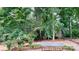 Landscaped backyard retreat with lush trees, flowers, and a stone paver patio at 4066 Belle Meade Cir, Belmont, NC 28012