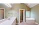 Bathroom featuring a large vanity, mirror, and separate tub at 4066 Belle Meade Cir, Belmont, NC 28012