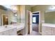 Bathroom featuring vanity, double mirror, tile floors, and bedroom doorway at 4066 Belle Meade Cir, Belmont, NC 28012