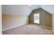 Upstairs bedroom featuring neutral paint and carpet, and a window for natural light at 4066 Belle Meade Cir, Belmont, NC 28012