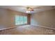 Spacious bedroom featuring a ceiling fan, neutral walls, and a large window, offering natural light at 4066 Belle Meade Cir, Belmont, NC 28012