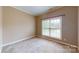 This cozy bedroom has neutral walls and a window with blinds, creating a calm and inviting space at 4066 Belle Meade Cir, Belmont, NC 28012