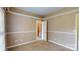Bedroom with neutral walls and carpet and white trim, as well as a view of a staircase at 4066 Belle Meade Cir, Belmont, NC 28012