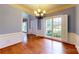 Formal dining room with wainscoting, hardwood floors, and a chandelier at 4066 Belle Meade Cir, Belmont, NC 28012