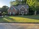 Traditional two-story brick home with a well-manicured lawn and mature trees at 4066 Belle Meade Cir, Belmont, NC 28012
