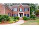 Charming two-story brick home with a beautifully landscaped front yard, classic shutters, and a welcoming entryway at 4066 Belle Meade Cir, Belmont, NC 28012