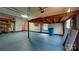 Large garage space with blue painted floor and storage and lighting at 4066 Belle Meade Cir, Belmont, NC 28012