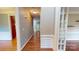 Long hallway with hardwood flooring and natural light at 4066 Belle Meade Cir, Belmont, NC 28012