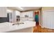 Open kitchen with white cabinetry, stainless appliances, breakfast bar, and hardwood flooring, perfect for cooking and entertaining at 4066 Belle Meade Cir, Belmont, NC 28012