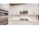 Modern kitchen featuring sleek white cabinets, stainless steel appliances, and a minimalist design at 4066 Belle Meade Cir, Belmont, NC 28012
