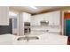 Well-lit kitchen showcasing white cabinets, stainless steel appliances, and a practical breakfast bar area at 4066 Belle Meade Cir, Belmont, NC 28012