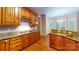Traditional kitchen featuring wood cabinetry, granite countertops, and hardwood flooring at 4066 Belle Meade Cir, Belmont, NC 28012