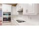 Close-up of the modern kitchen featuring stainless steel appliances and white cabinets with minimalist hardware at 4066 Belle Meade Cir, Belmont, NC 28012