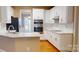 Bright kitchen featuring white cabinets, stainless steel appliances, and a breakfast bar, perfect for modern living at 4066 Belle Meade Cir, Belmont, NC 28012