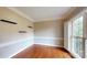 Bright living room featuring hardwood floors, white trim, and large shuttered windows at 4066 Belle Meade Cir, Belmont, NC 28012