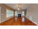 Spacious living room with hardwood floors, fireplace, and many shuttered windows at 4066 Belle Meade Cir, Belmont, NC 28012