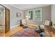 Bright and airy office space featuring hardwood floors, neutral walls, and natural light streaming through a large window at 409 W Kingston Ave, Charlotte, NC 28203