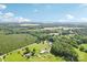 Expansive aerial view of land, trees, and several buildings, featuring lush greenery and a clear blue sky at 4122 Canal Rd, Marshville, NC 28103
