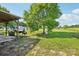 Spacious backyard with a large tree and back porch at 4122 Canal Rd, Marshville, NC 28103