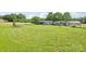Spacious backyard with lush green grass, play equipment, a trailer, and shed provides lots of outdoor activities at 4122 Canal Rd, Marshville, NC 28103