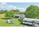 Expansive yard with playhouse, RV, and covered patio offering ample space for relaxation and outdoor entertainment at 4122 Canal Rd, Marshville, NC 28103