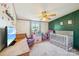 Bright, well-lit Bedroom featuring a crib, ceiling fan, and toys at 4122 Canal Rd, Marshville, NC 28103