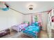 Charming bedroom showcasing two twin beds with colorful bedding, whimsical decor, and lots of natural light at 4122 Canal Rd, Marshville, NC 28103