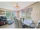 Cozy dining area includes a rustic wooden table, patterned chairs, and bright natural light from the large windows at 4122 Canal Rd, Marshville, NC 28103
