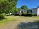 Charming single-story home with a welcoming front porch and well-maintained lawn and attractive landscaping at 4122 Canal Rd, Marshville, NC 28103