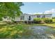 Well-maintained home with green lawn and mature trees on a sunny day at 4122 Canal Rd, Marshville, NC 28103