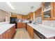 Well-lit kitchen boasts wood cabinets, modern black appliances, and a stylish countertop with ample space at 4122 Canal Rd, Marshville, NC 28103