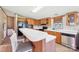 Bright kitchen offers a breakfast bar with barstools, wooden cabinets, and modern appliances for efficient cooking at 4122 Canal Rd, Marshville, NC 28103