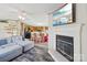 Open-concept living room with a fireplace, TV, and a view into the modern kitchen with a breakfast bar at 4122 Canal Rd, Marshville, NC 28103