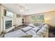 Bright living room features a cozy fireplace and a large sectional sofa with natural light from large windows at 4122 Canal Rd, Marshville, NC 28103