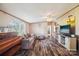 Cozy living room with hardwood floors, a gray couch, and an entertainment center at 4122 Canal Rd, Marshville, NC 28103