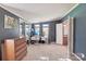 Spacious main bedroom offers blue walls, carpet, a wardrobe, and a desk area, creating a comfortable and versatile living space at 4122 Canal Rd, Marshville, NC 28103