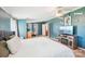 Well-lit main bedroom with a king bed, wooden entertainment center, and views of an adjacent area with a desk at 4122 Canal Rd, Marshville, NC 28103