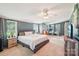 Spacious main bedroom boasts blue paneled walls, plush carpet, and a comfortable king-sized bed with ample natural light at 4122 Canal Rd, Marshville, NC 28103