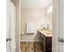 Bright bathroom with a modern vanity, large mirror, and decorative orchids at 415 Tayberry Ln, Fort Mill, SC 29715