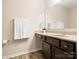 Bathroom featuring a granite countertop, large mirror, and modern finishes at 415 Tayberry Ln, Fort Mill, SC 29715