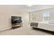 Bright bedroom featuring neutral carpeting, two windows, a bed, and a television stand at 415 Tayberry Ln, Fort Mill, SC 29715