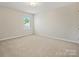 Bedroom with neutral carpet, a window, and overhead lighting fixture at 415 Tayberry Ln, Fort Mill, SC 29715
