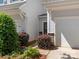Home's front exterior with lush bushes flanking a garage door and front door with a wreath at 415 Tayberry Ln, Fort Mill, SC 29715