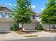A row of townhomes with garages and landscaped yards, under a blue sky at 415 Tayberry Ln, Fort Mill, SC 29715