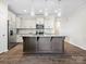 Well-lit kitchen features granite countertops, stainless appliances, and a central island at 415 Tayberry Ln, Fort Mill, SC 29715