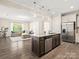 Open-concept kitchen with granite island, stainless steel appliances, and seamless flow to the living area at 415 Tayberry Ln, Fort Mill, SC 29715