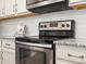 Close-up of a stainless steel oven with granite countertops and white cabinets in a modern kitchen at 415 Tayberry Ln, Fort Mill, SC 29715