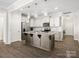 Spacious kitchen with a center island, stainless steel appliances, and seamless access to other rooms at 415 Tayberry Ln, Fort Mill, SC 29715